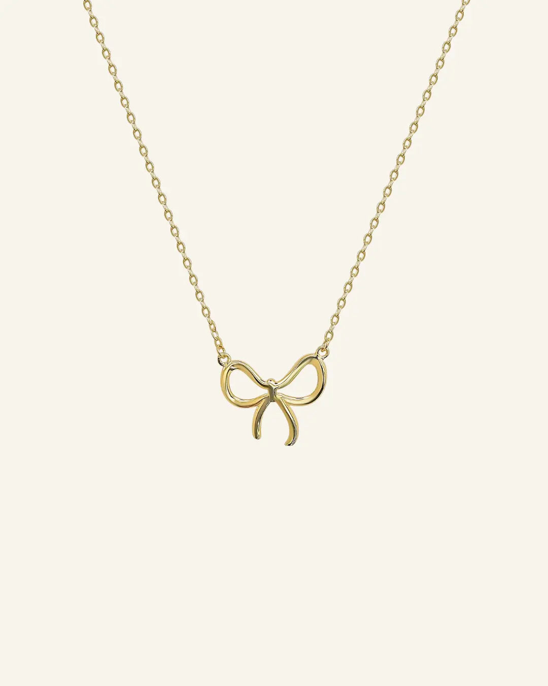 Close-up of bow pendant necklace in 18k gold filled