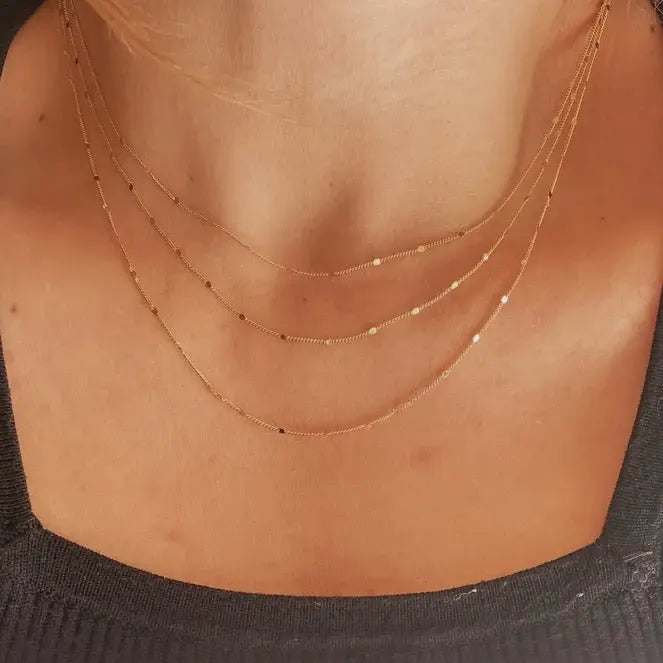 Close-up of Curb Pressed Chain Necklace styled in layered look, 18k gold-filled jewelry by IGGI Jewellery