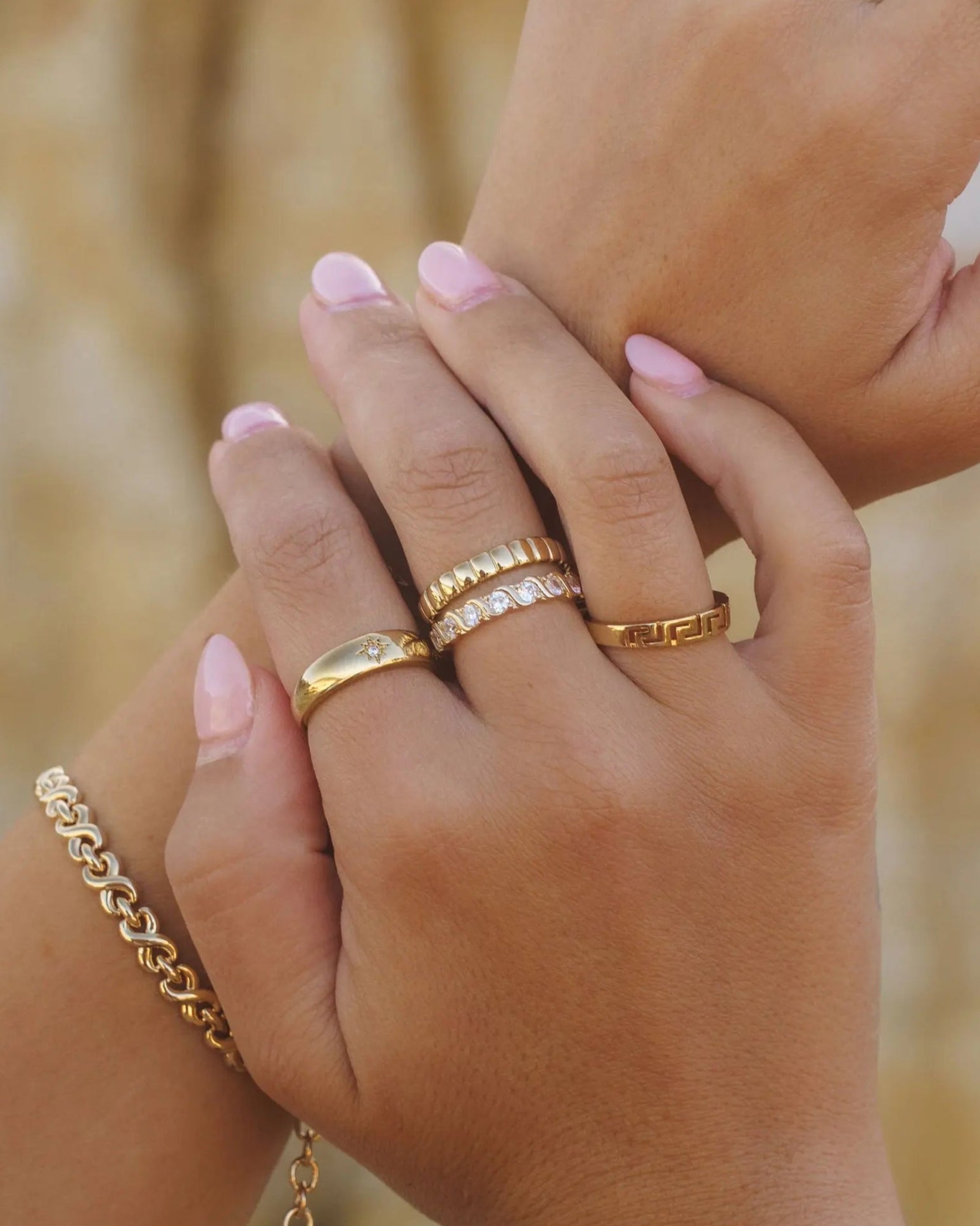 Close-up of Donella Ring styled with other IGGI gold rings and bracelets