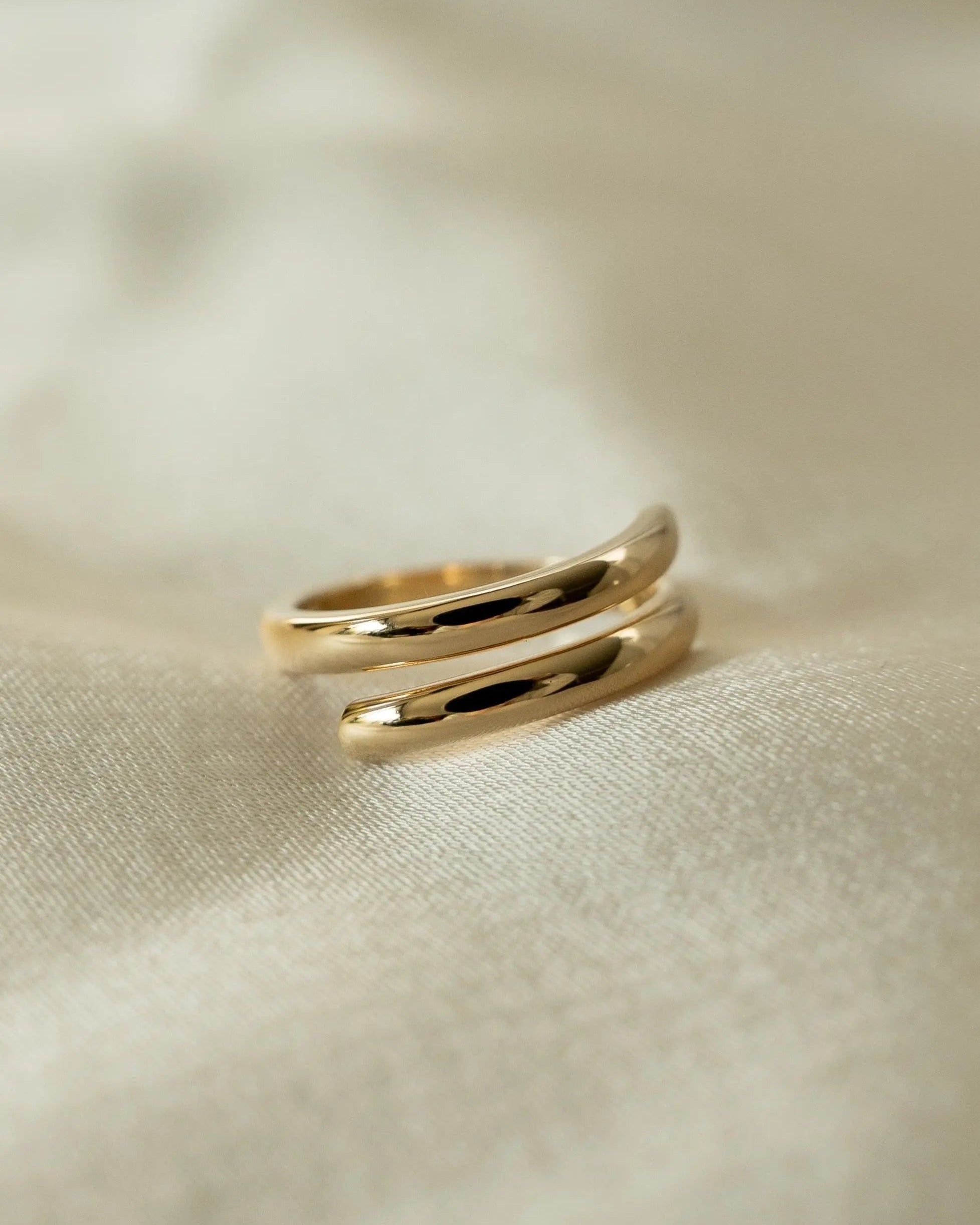 Etta Ring 18k gold-filled displayed on fabric background.