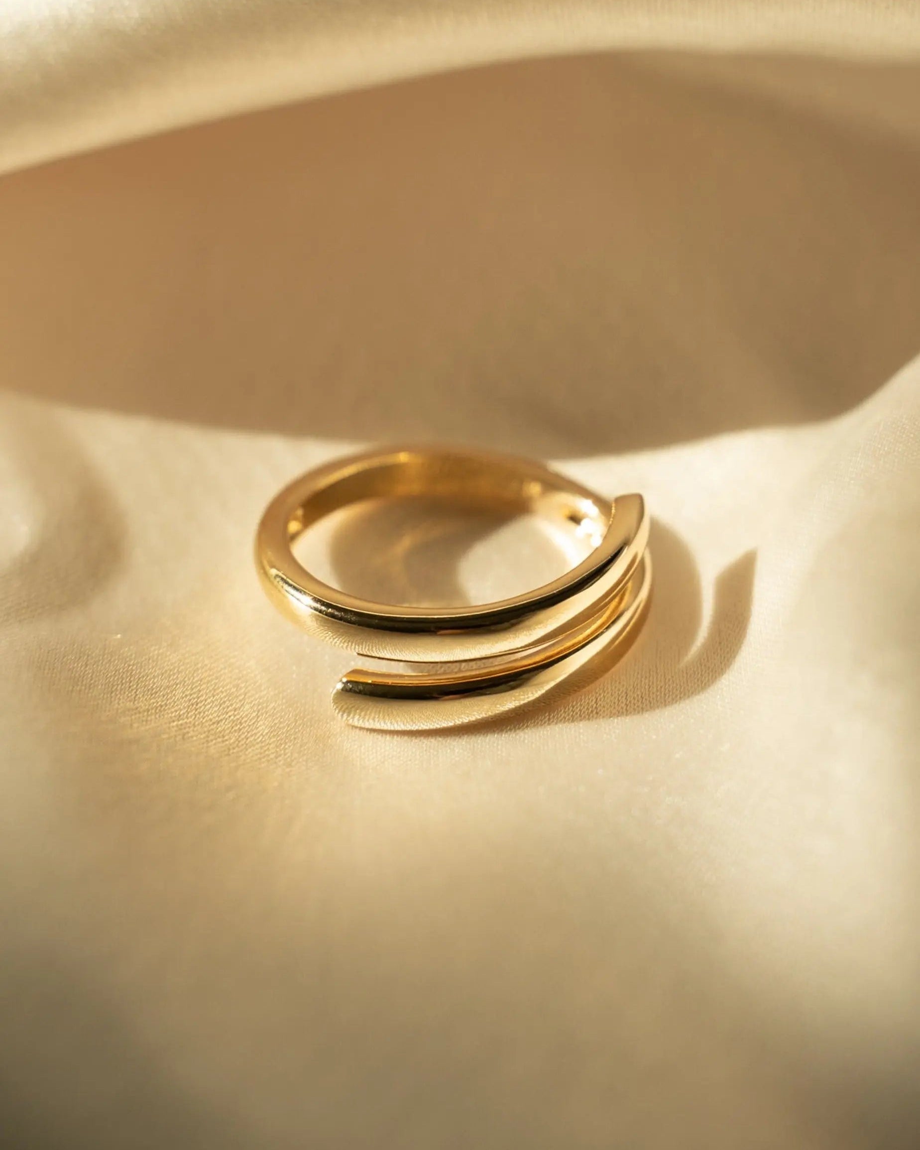 Side angle of Etta Ring showing smooth curved design in gold-filled material.