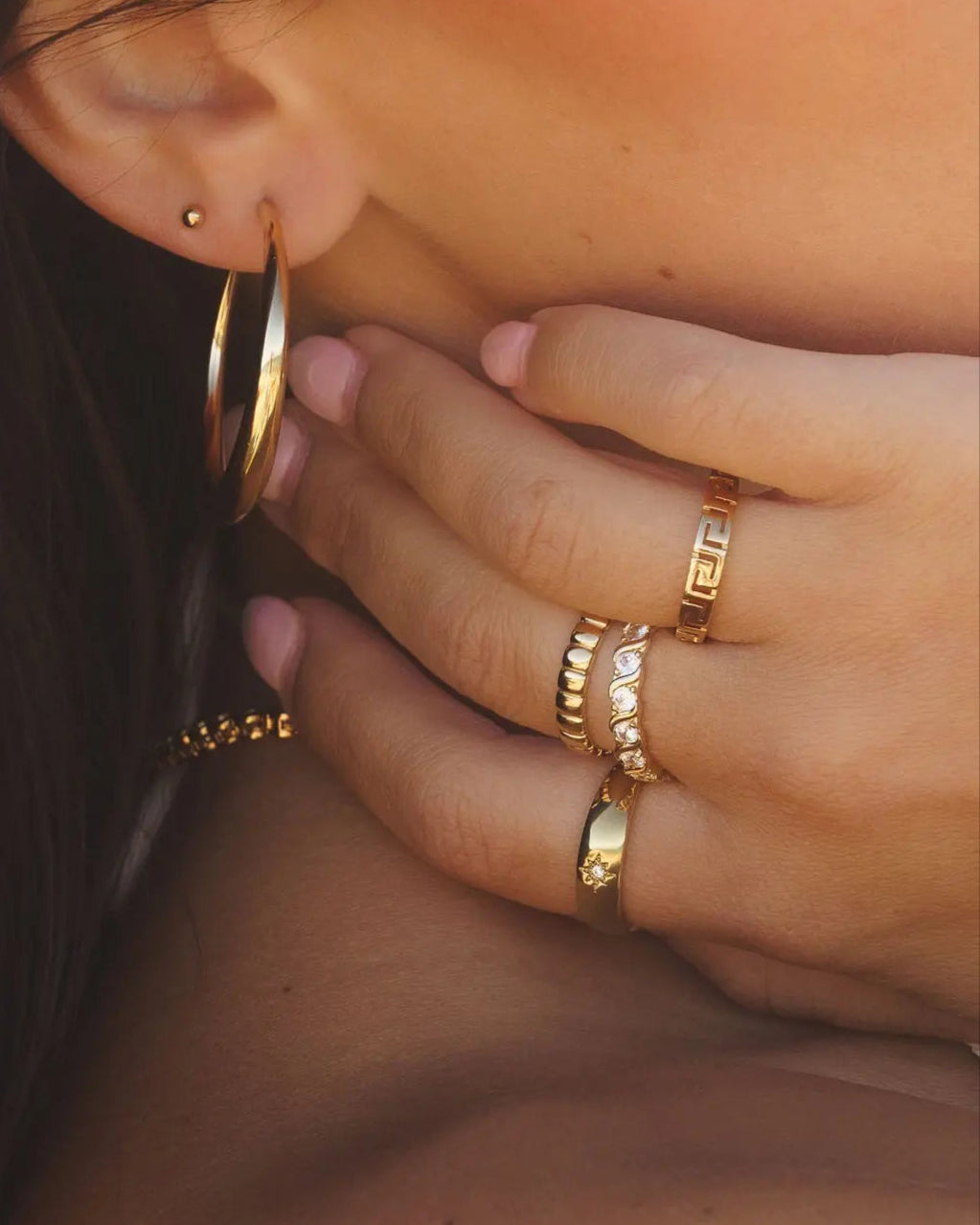Ettore Ring styled on model's hand with layered gold rings by IGGI Jewellery