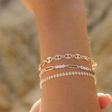 Francesca Bracelet styled with layered gold chain bracelets on wrist, featuring crystal accents by IGGI Jewellery.