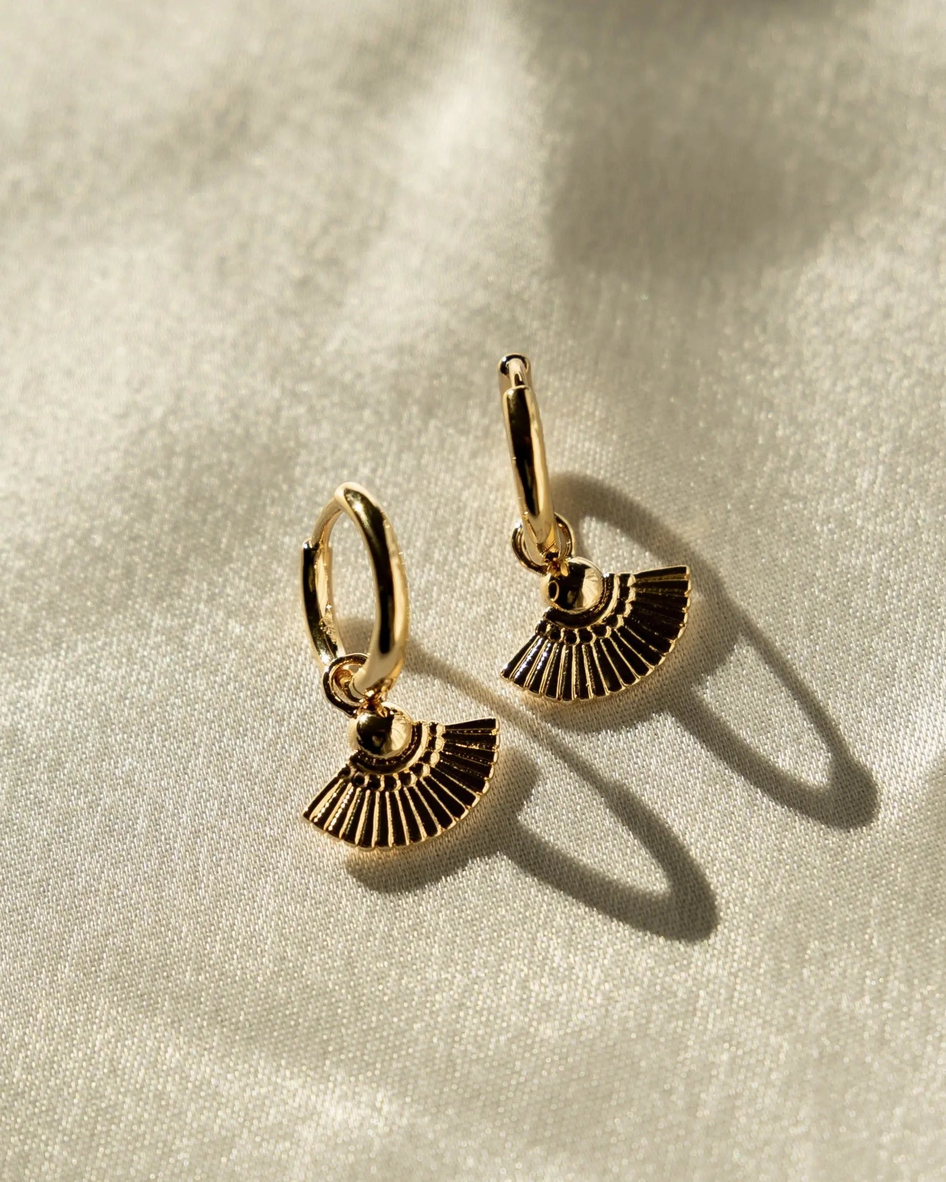 Heka Hoops 18k gold-filled hoop earrings styled on fabric