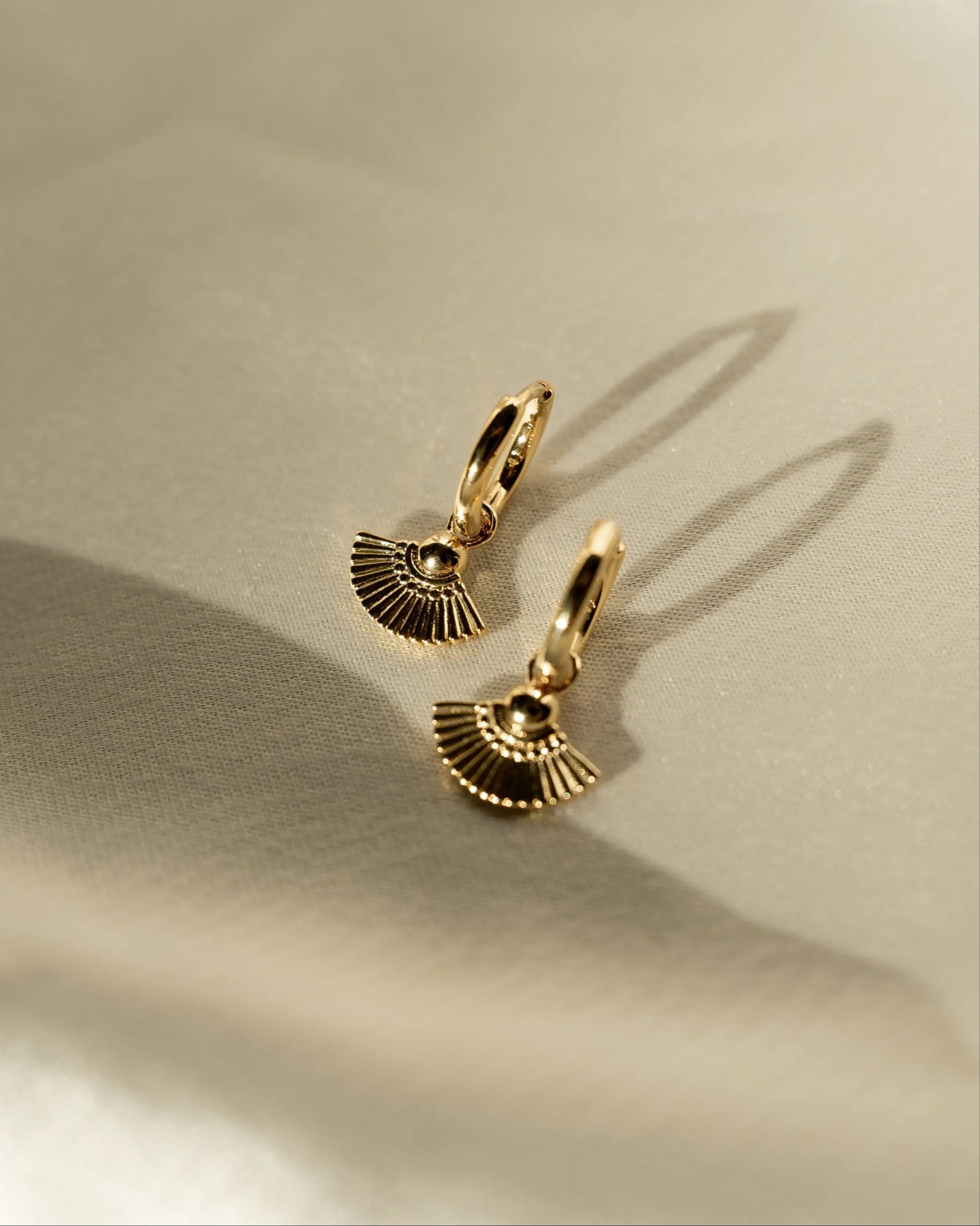 Heka Hoops 18k gold-filled hoop earrings styled on fabric