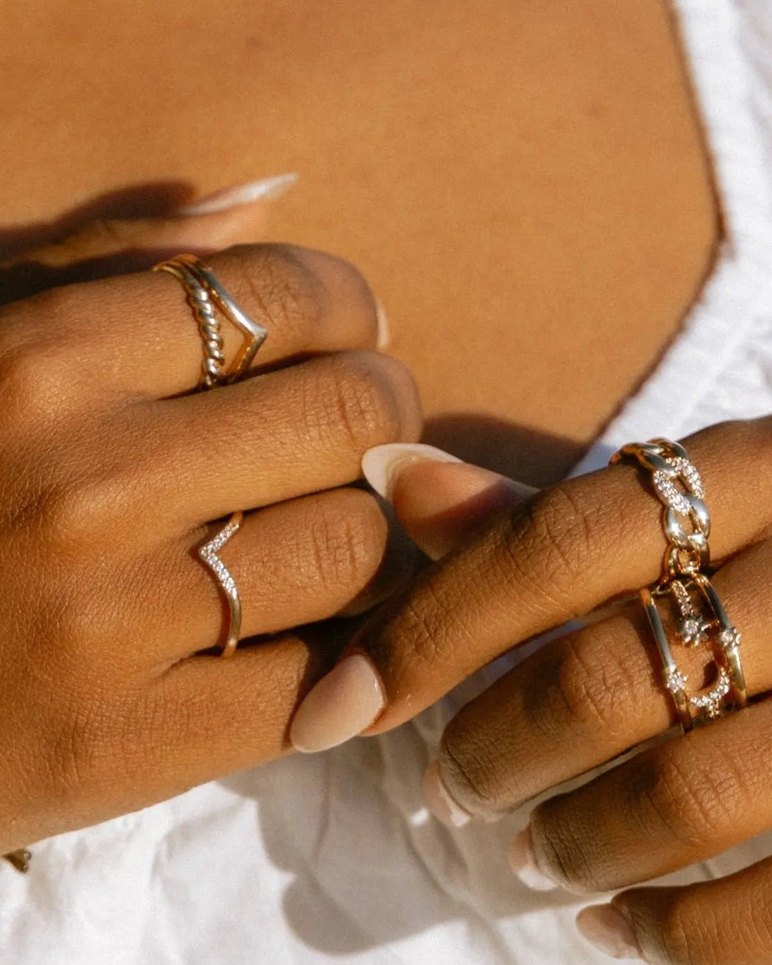 Lifestyle photo of Lexi Ring worn with multiple gold rings