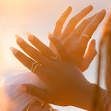 Lexi Ring stacked with other IGGI gold rings for a layered look