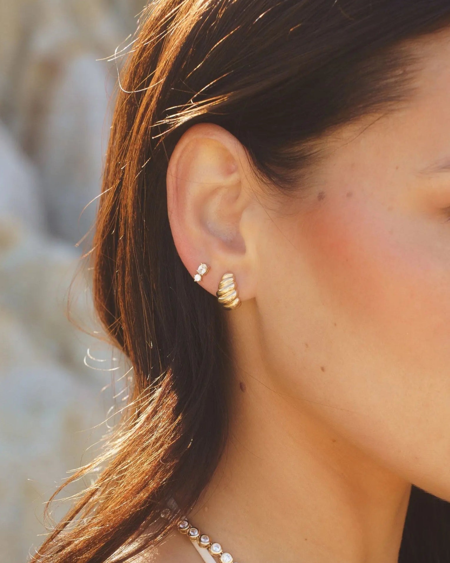 Model wearing Moxie Twisted C-Hoop earrings in 18k gold-filled by IGGI Jewellery