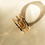 Flat lay of Nova Ring with sparkling stone accents on neutral fabric