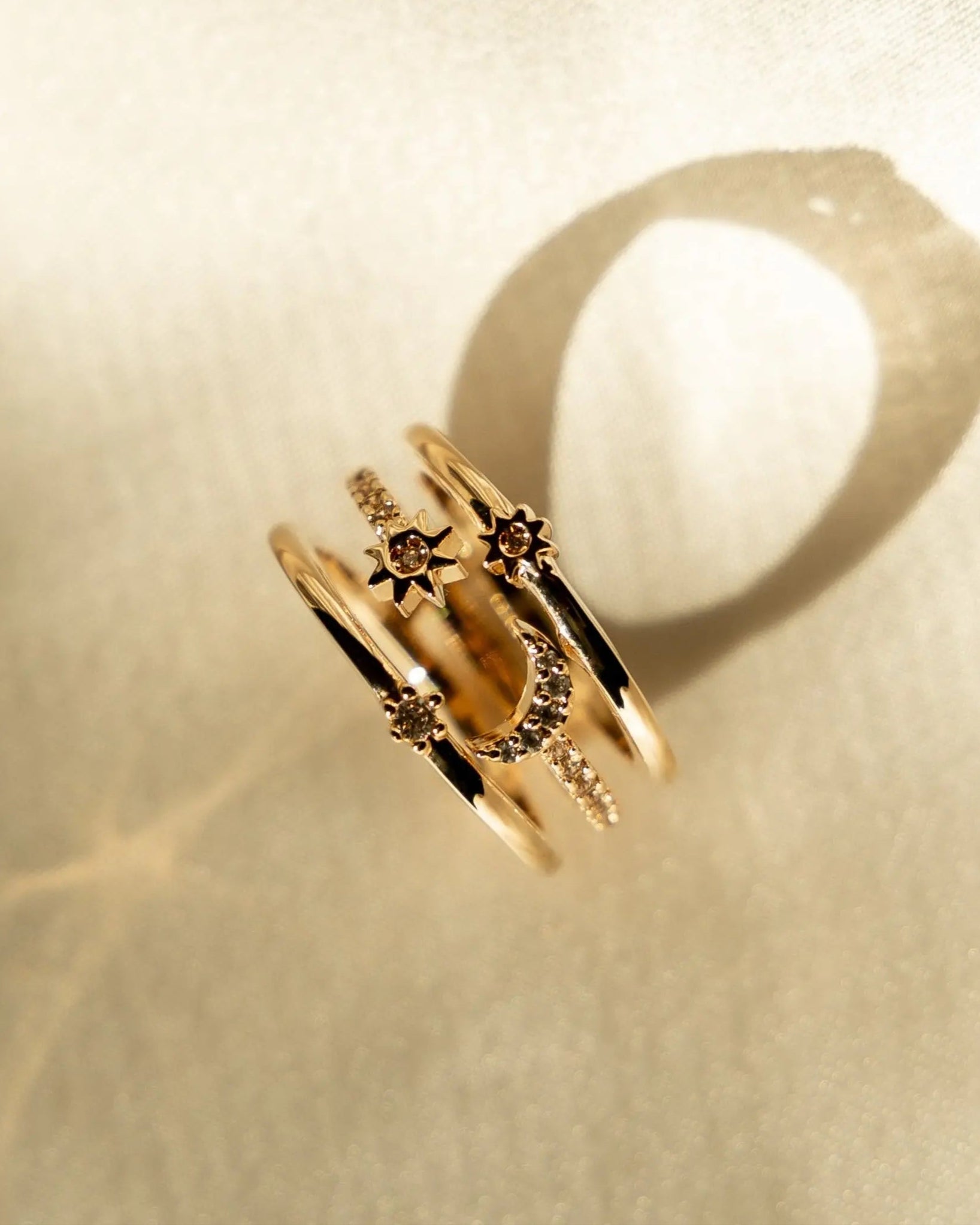 Flat lay of Nova Ring with sparkling stone accents on neutral fabric