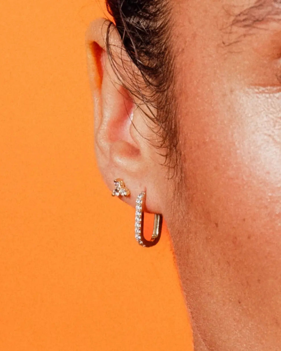 Close-up of Paperclip Hoops CZ by IGGI Jewellery – 18k gold-filled huggie hoops with cubic zirconia, worn in ear for styling inspiration.