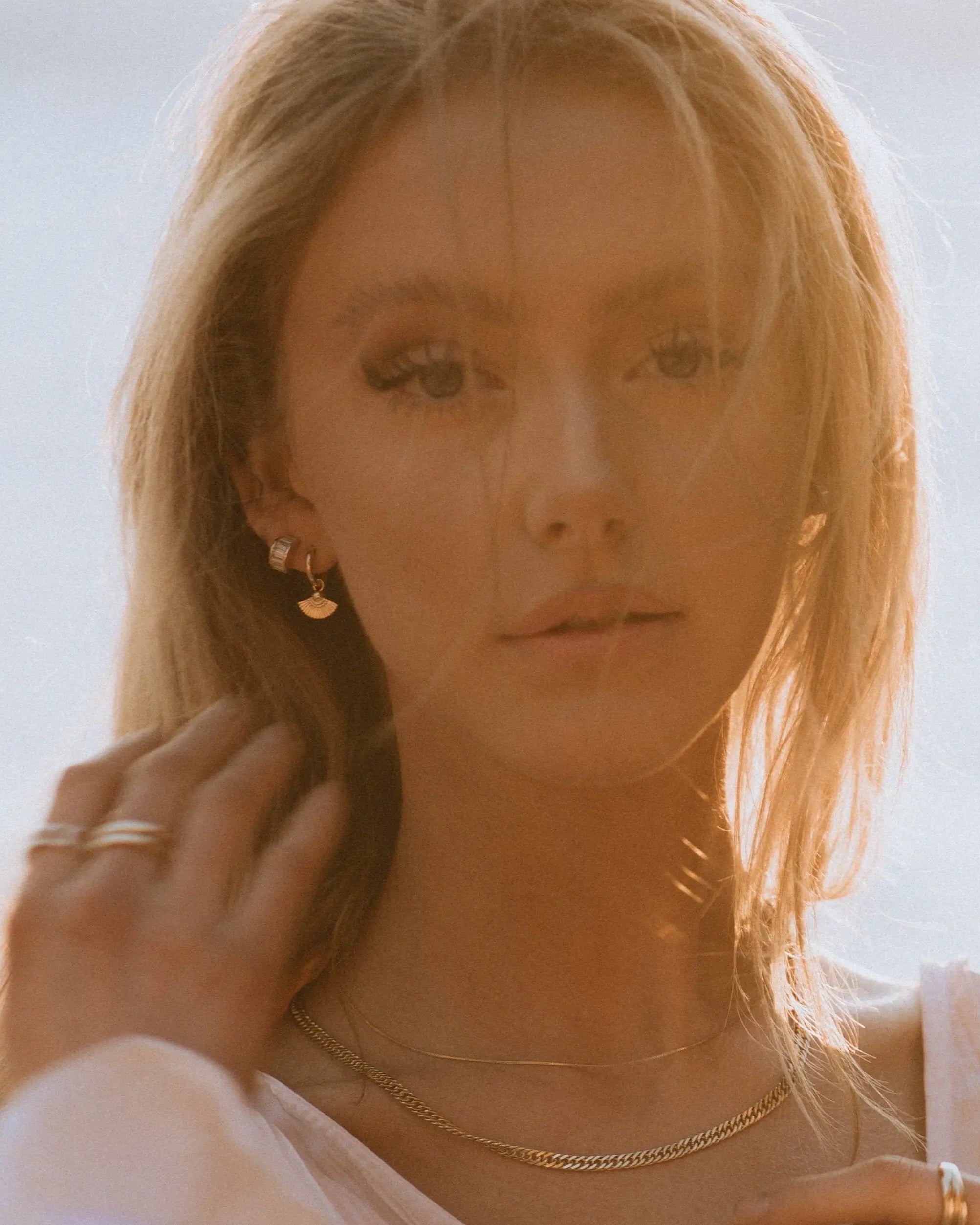 Sonia Studs 18k gold-filled earrings worn by model outdoors in warm sunlight