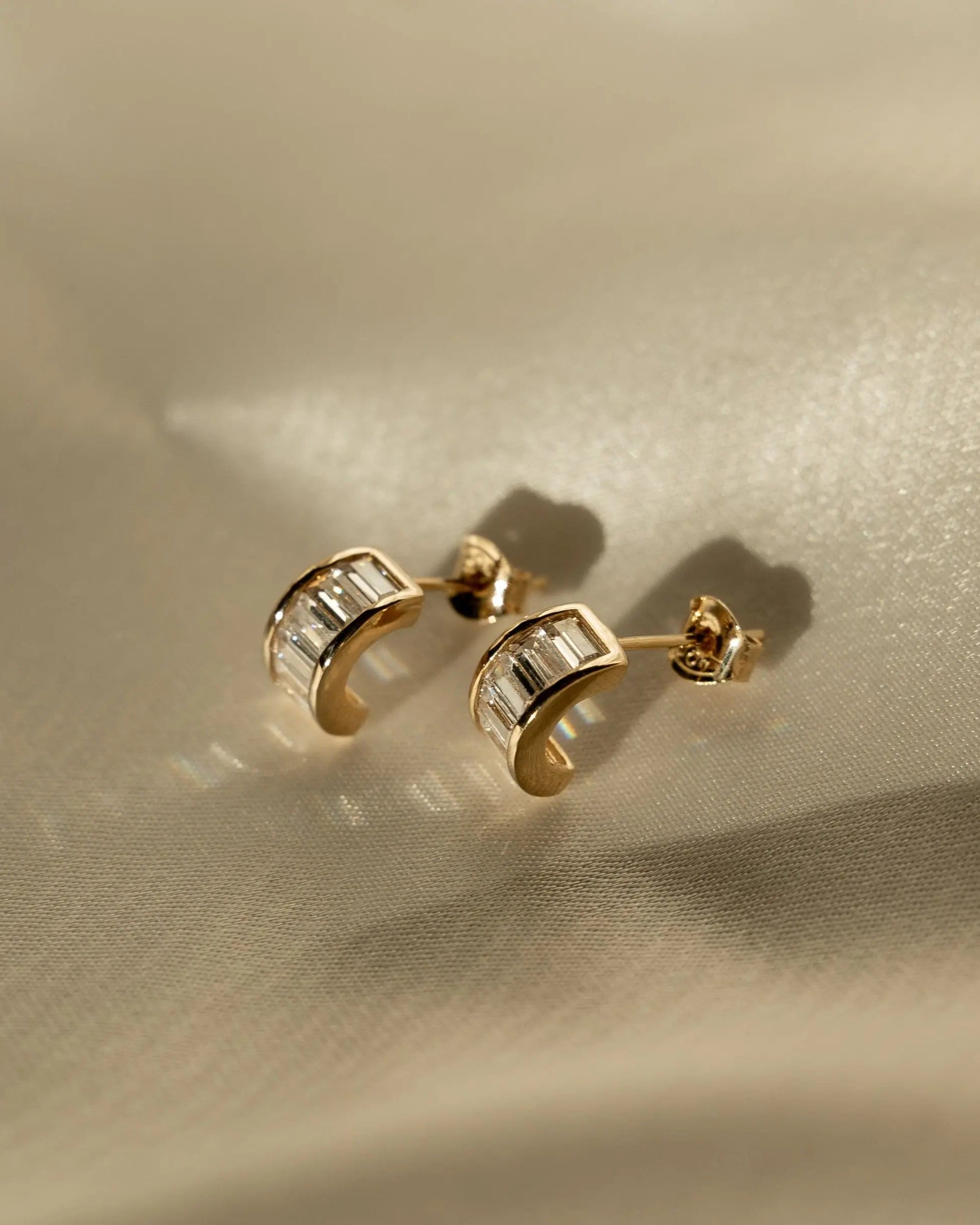 Sonia Studs 18k gold-filled hoop earrings with baguette-cut CZ stones on a neutral background