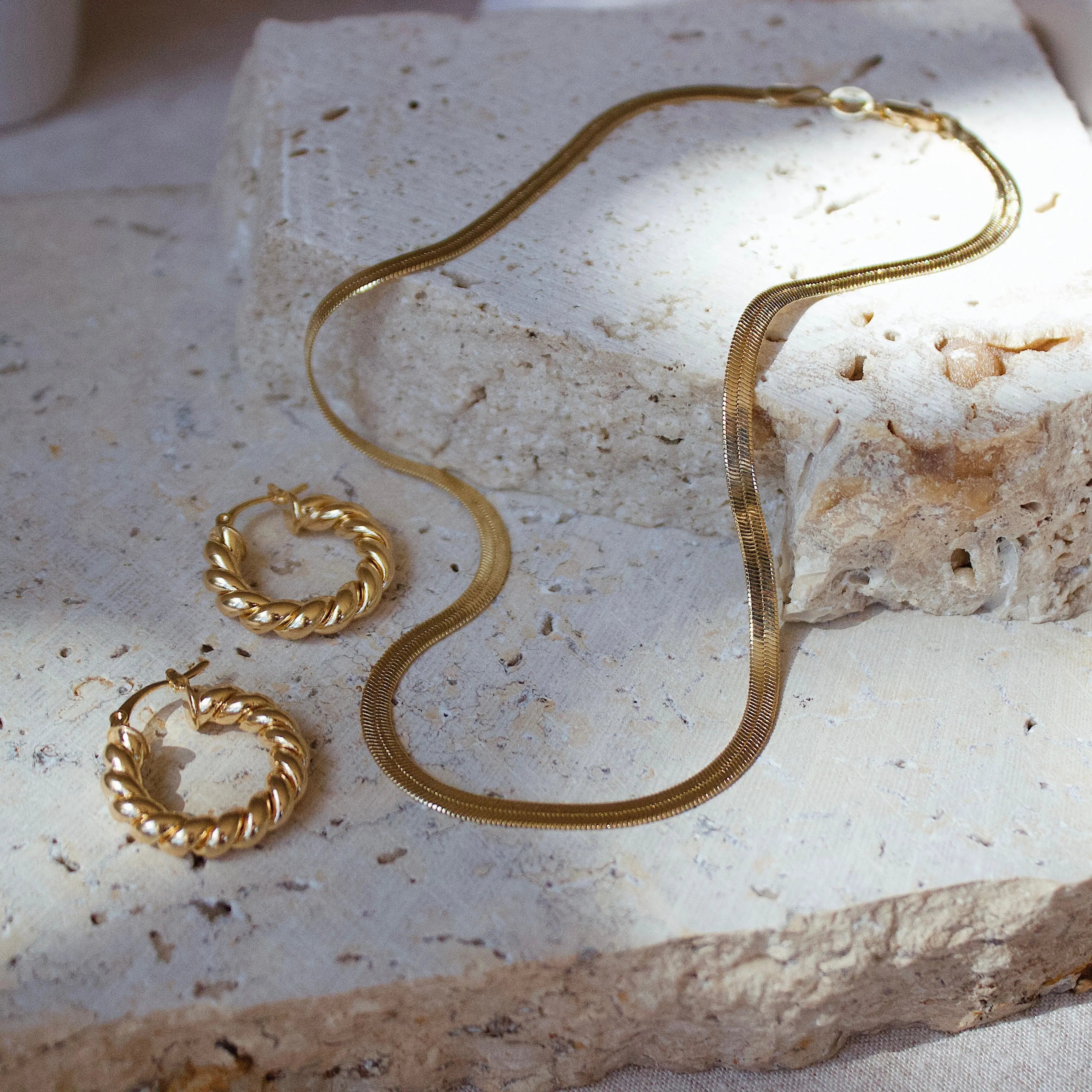 Close-up of model wearing 4mm gold-filled herringbone chain necklace – delicate and radiant
