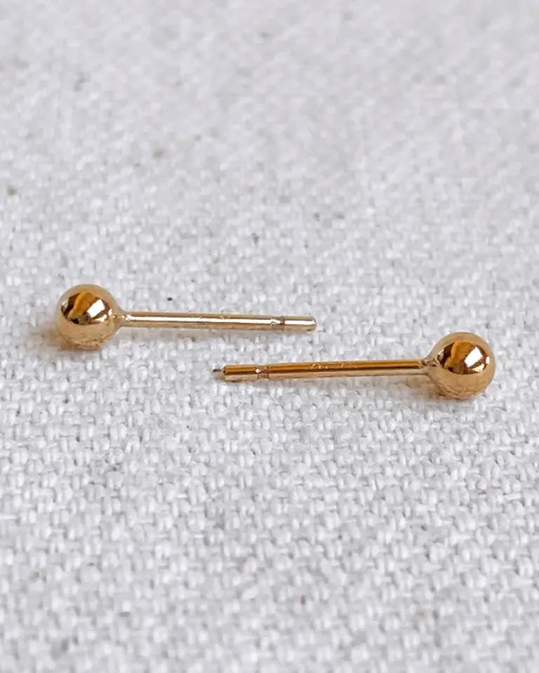 Everyday Ball Stud Earrings – flat lay on neutral fabric background