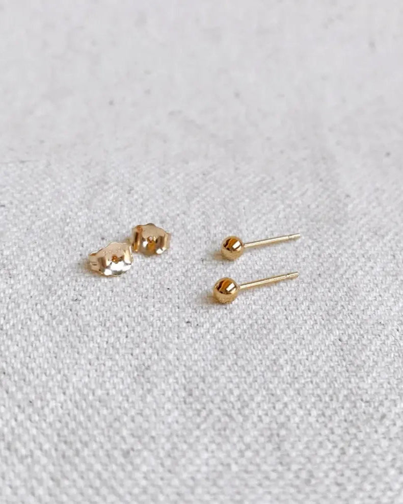 Everyday Ball Studs styled with additional earrings on model’s ear