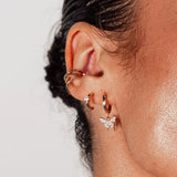 Bella C Hoop Studs styled on ear – 18k gold-filled with CZ stone