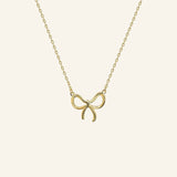 Close-up of bow pendant necklace in 18k gold filled