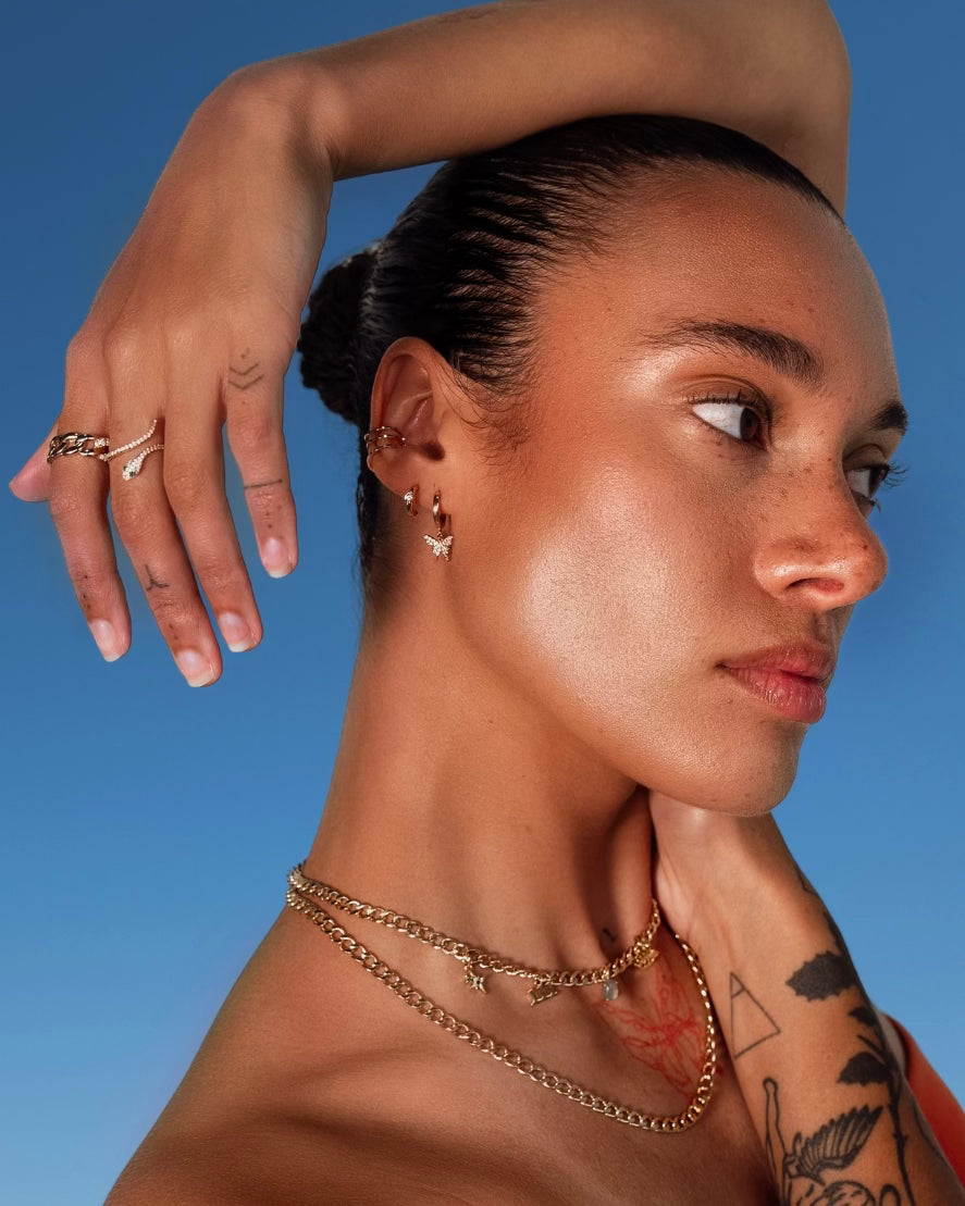 Model wearing Butterfly Drop Huggies by IGGI Jewellery – 18k gold-filled butterfly earrings styled with layered gold chains.
