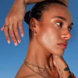 Model wearing Butterfly Drop Huggies by IGGI Jewellery – 18k gold-filled butterfly earrings styled with layered gold chains.