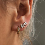 Close-up of ear wearing Cluster Curved Stud Earrings in 18k gold-filled
