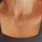 Close-up of Curb Pressed Chain Necklace styled in layered look, 18k gold-filled jewelry by IGGI Jewellery