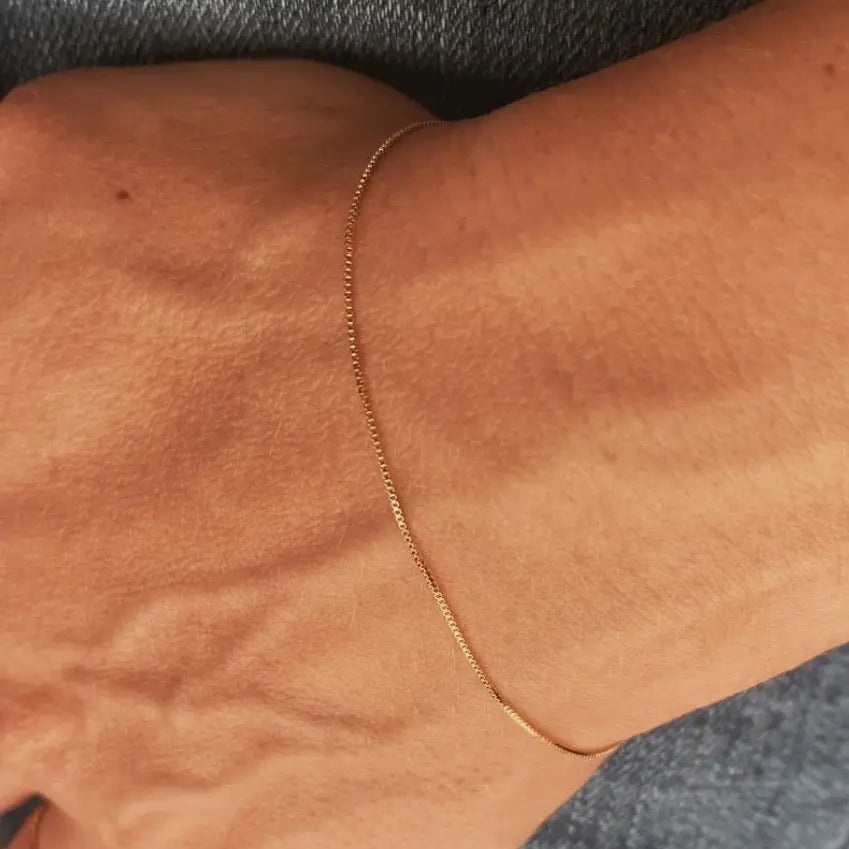 Dainty Box Chain Bracelet styled close-up on wrist, delicate gold detail by IGGI Jewellery