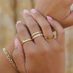 Close-up of Donella Ring styled with other IGGI gold rings and bracelets