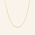 Dotted Chain Necklace in 18k gold-filled shown on a neutral background in flatlay view