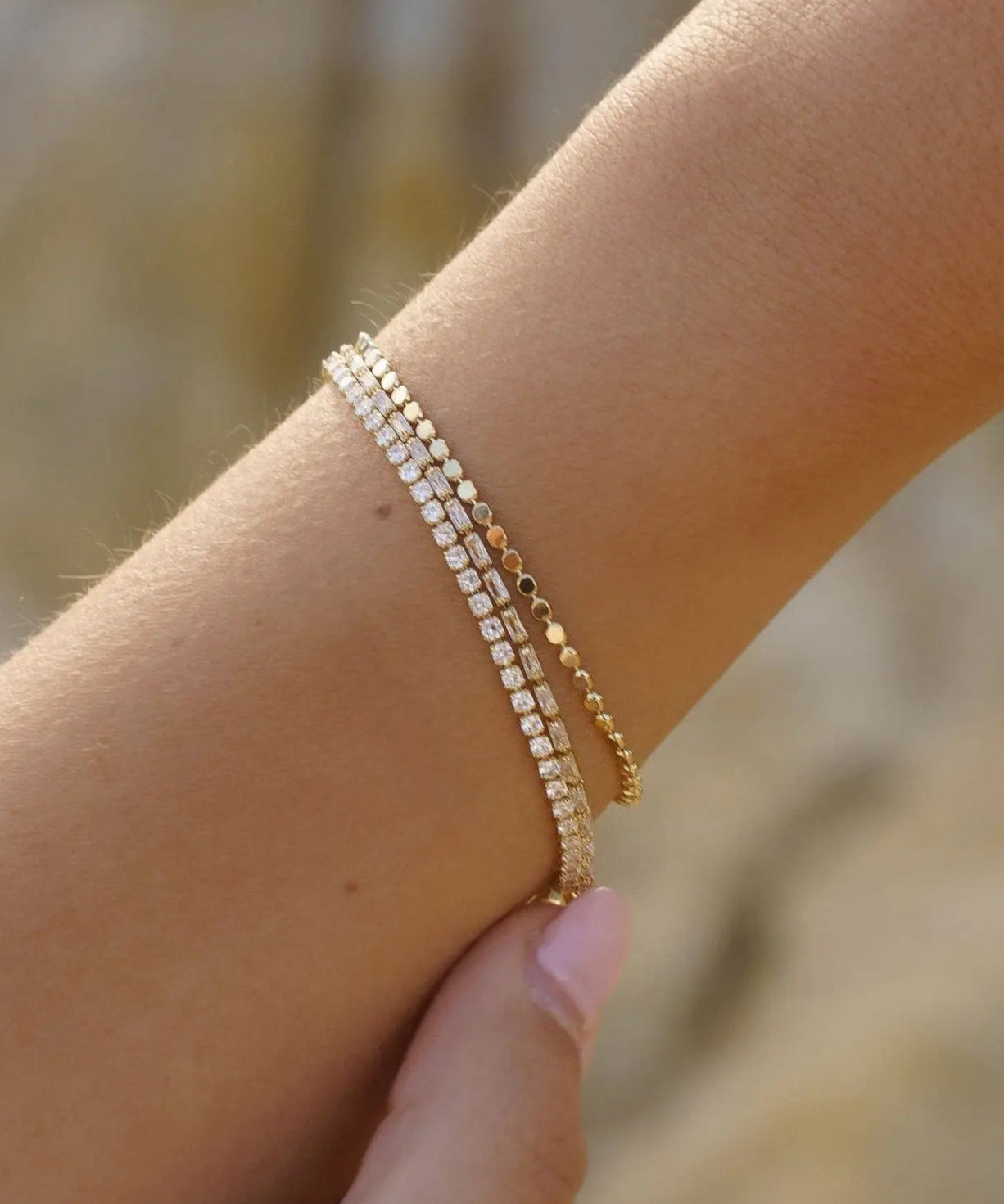 Gold Dotted Dainty Bracelet layered with other IGGI gold bracelets on wrist