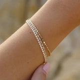 Gold Dotted Dainty Bracelet layered with other IGGI gold bracelets on wrist