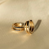 Double Huggie Hoops in 18k gold-filled displayed on satin fabric for IGGI Jewellery