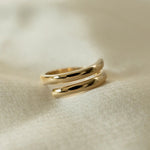 Etta Ring 18k gold-filled displayed on fabric background.