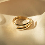 Side angle of Etta Ring showing smooth curved design in gold-filled material.