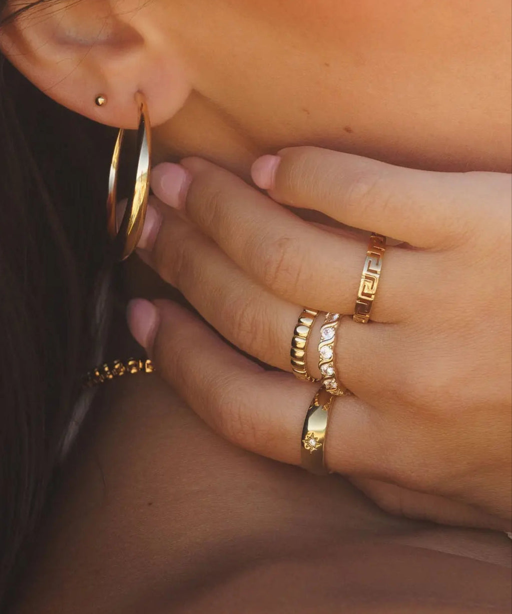 Ettore Ring styled on model's hand with layered gold rings by IGGI Jewellery