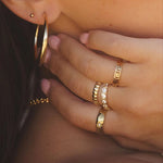Ettore Ring styled on model's hand with layered gold rings by IGGI Jewellery