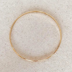 Fine Gold Bangle flat lay - gold-filled minimal bracelet by IGGI Jewellery