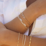 Francesca Bracelet styled with layered gold bracelets, featuring mixed textures and polished finish by IGGI Jewellery.
