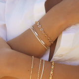 Francesca Bracelet styled with layered gold bracelets, featuring mixed textures and polished finish by IGGI Jewellery.