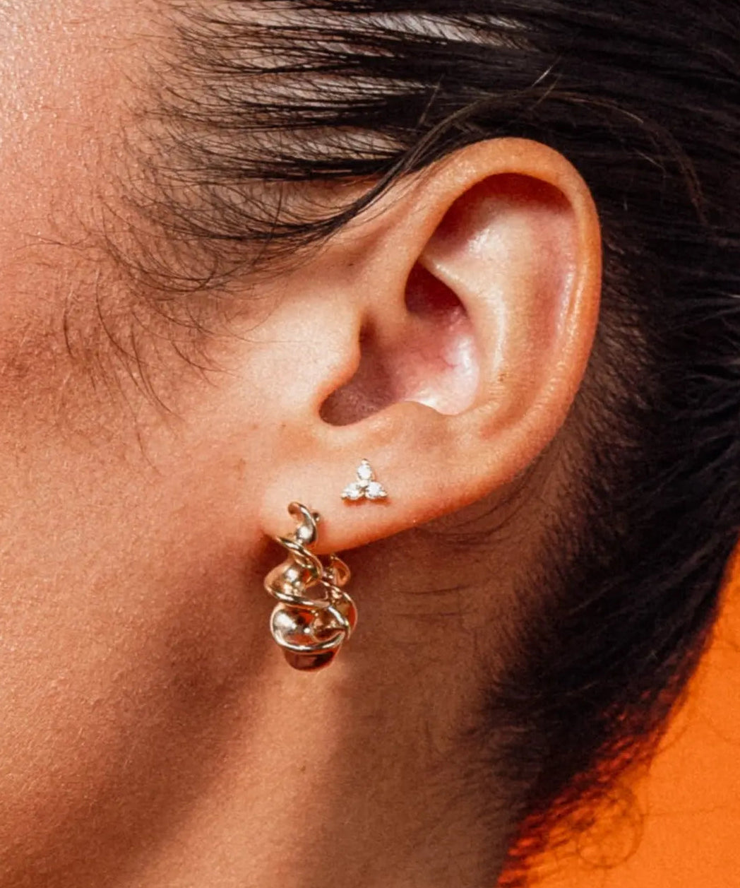 Model wearing Gold Tri CZ Stud Earrings with cubic zirconia stones by IGGI Jewellery