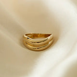 Close-up of Halona Ring on fabric, showcasing gold-filled dome band design