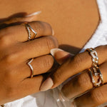 Lifestyle photo of Lexi Ring worn with multiple gold rings