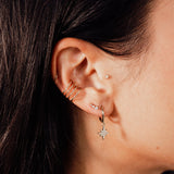 Lola Mini Studs styled in an ear piercing stack with gold hoops and star drop earrings by IGGI Jewellery.
