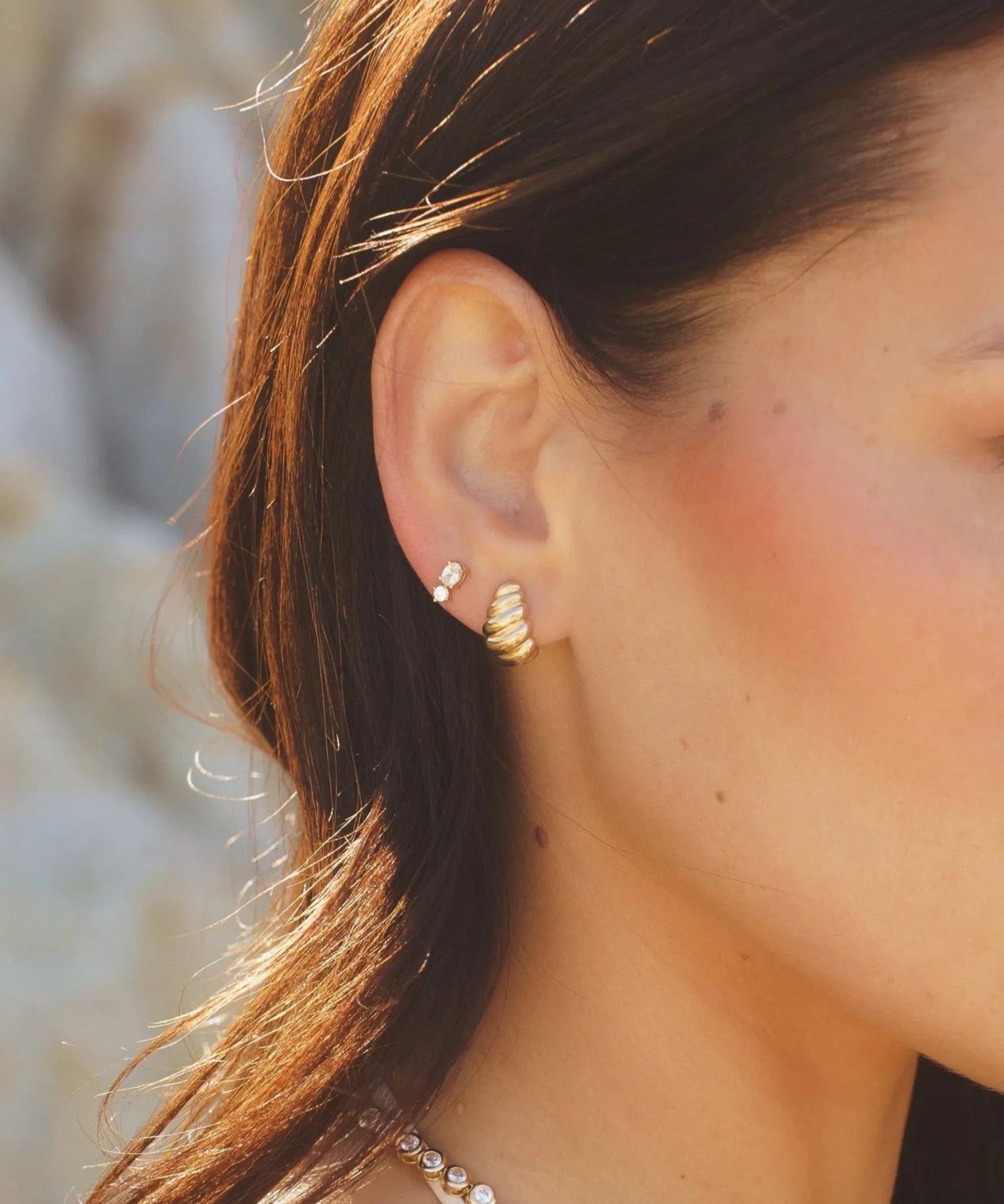 Model wearing Moxie Twisted C-Hoop earrings in 18k gold-filled by IGGI Jewellery