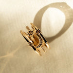 Flat lay of Nova Ring with sparkling stone accents on neutral fabric