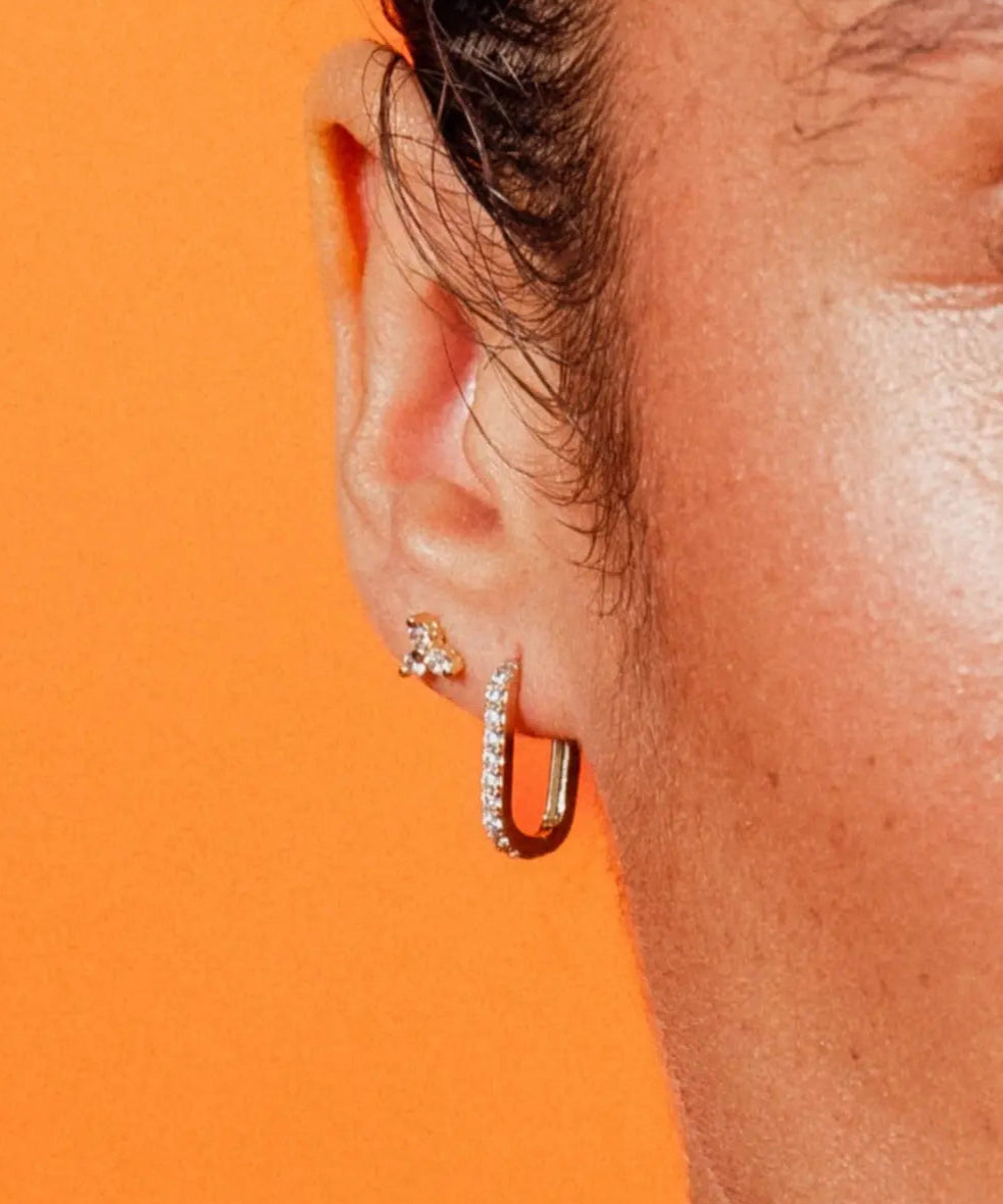 Close-up of Paperclip Hoops CZ by IGGI Jewellery – 18k gold-filled huggie hoops with cubic zirconia, worn in ear for styling inspiration.