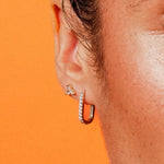 Close-up of Paperclip Hoops CZ by IGGI Jewellery – 18k gold-filled huggie hoops with cubic zirconia, worn in ear for styling inspiration.
