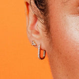 Close-up of Paperclip Hoops CZ by IGGI Jewellery – 18k gold-filled huggie hoops with cubic zirconia, worn in ear for styling inspiration.