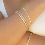 Rope Chain Bracelet stacked with gold chain bracelets on wrist for an elegant layered look.
