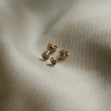 Close-up of Round Disc Studs in 18k gold-filled minimalist style